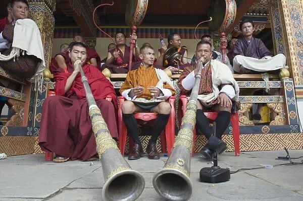 Monks playing horns and drums, Autumn Tsechu (festival) at Trashi Chhoe Dzong
