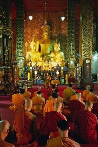 Monks seated inside temple