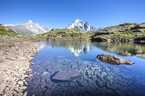The Mont Blanc mountain range reflected in the waters of Lac des Cheserys, Haute Savoie