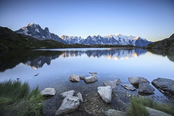 Mont Blanc range reflected at sunrise from the shore of Lac des Cheserys, Aiguilles Rouges