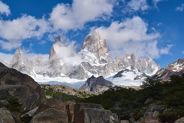 Monte Fitz Roy framed by rocks and trees near Arroyo del Salto in Patagonia, Argentina