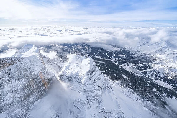 Monte Pelmo surrounded by a sea of clouds in winter, aerial view, Dolomites