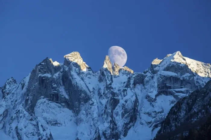 Framed Print : The moon appears behind the snowy mountains illuminating the peaks at sunset, Bondasca Valley Framed Print : The moon appears behind the snowy mountains illuminating the peaks at sunset, Bondasca Valley