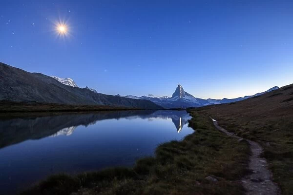 Full moon and Matterhorn illuminated for the 150th anniversary of the first ascent