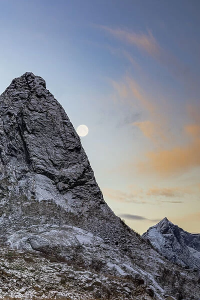 Full moon over the rock peak of Navaron mountain, Reine, Nordland county, Lofoten Islands