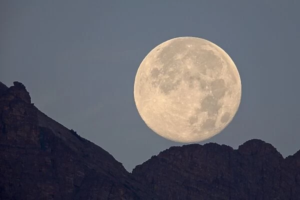 Full moon setting above a ridge, Glacier National Park, Montana, United States of America, North America