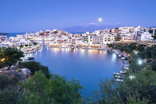 Moonlight over the old town of Agios Nikolaos and lake at dusk, Lasithi prefecture, Crete