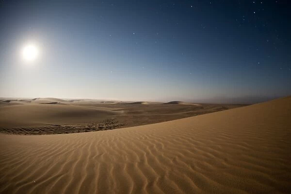 Moonrise over sand dunes, Skeleton Coast National Park, Namibia, Africa