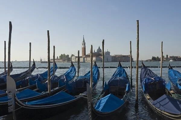Moored gondolas and the island church of San Giorgio Maggiore, Venice, UNESCO World Heritage Site