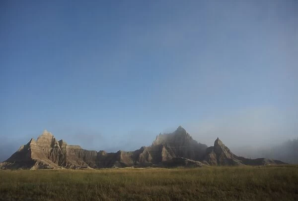Morning mist rises in Badlands National Park, South Dakota, United States of America