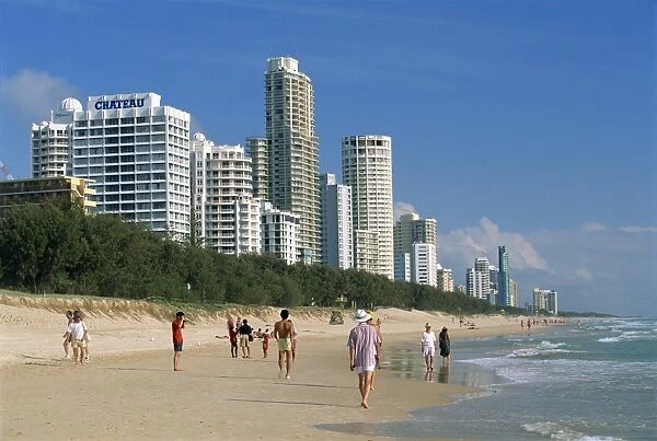 Morning walkers on the beach at the resort of Surfers Paradise on the Gold Coast of Queensland