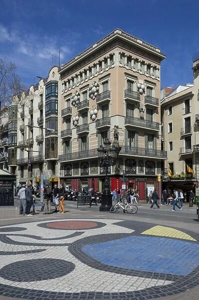 A mosaic pavement by Miro and building decorated with Umbrellas, on Las Ramblas, Barcelona, Catalunya, Spain, Europe