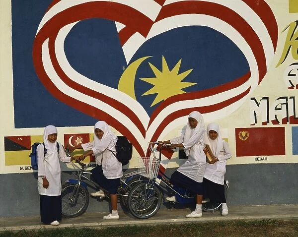 Moslem girls on bicycles in Malaysia