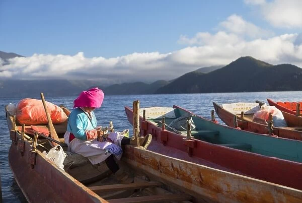 Mosu woman on boat, Luoshui, Lugu Lake, Yunnan, China, Asia