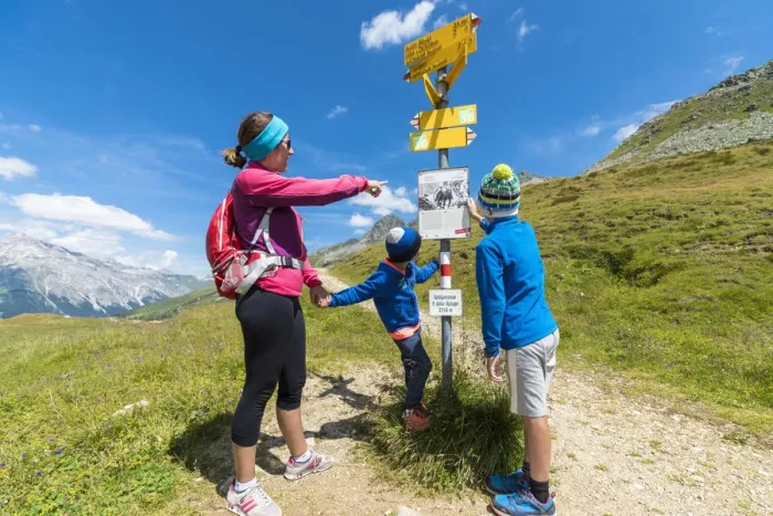 Framed Print : Mother and sons look at the signpost of hiking trails, Spluga Pass, Chiavenna Valley Framed Print : Mother and sons look at the signpost of hiking trails, Spluga Pass, Chiavenna Valley