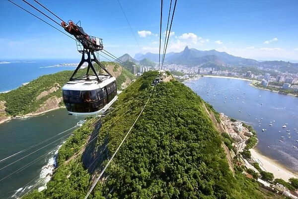 A motion blurred cable car approaches the station atop Sugarloaf mountain, with sweeping