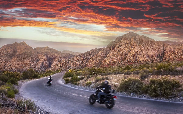 Motocycles driving through The Red Rock Canyon National Recreation Area at sunset