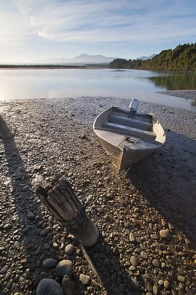 Motor boat at sunrise, Okarito Lagoon, West Coast, South Island, New Zealand, Pacific