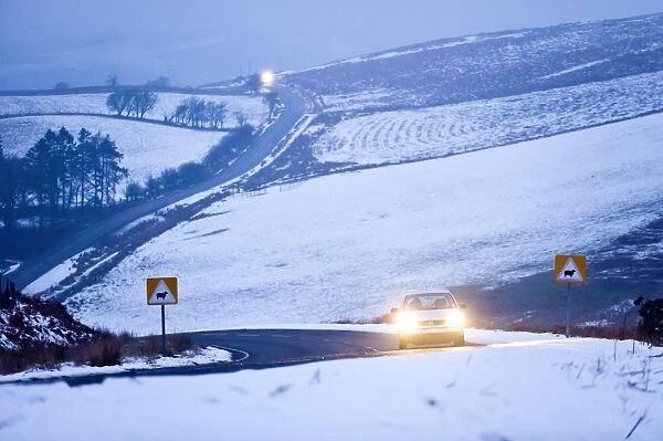 A motorist drives through a wintry landscape on the B4520, Brecon Road, on the Mynydd