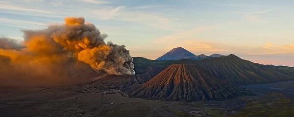 Mount Bromo (Gunung Bromo), an active volcano, erupting at sunrise throwing up ash clouds, East Java, Indonesia, Southeast Asia, Asia