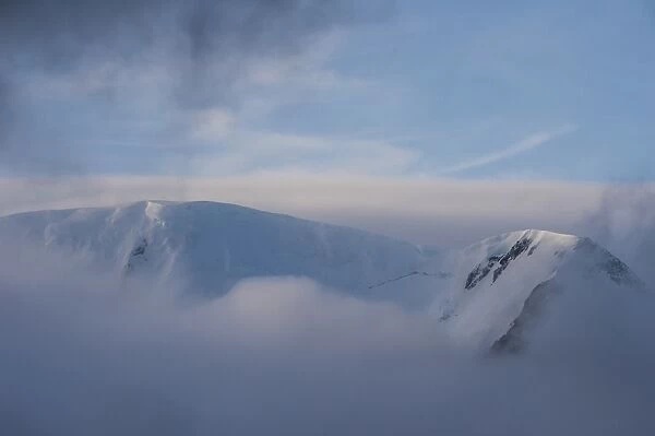 Mountain breaking through the clouds, Elephant Island, South Shetland Islands, Antarctica