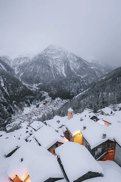 Mountain huts covered with snow in the alpine village of Starleggia, Campodolcino