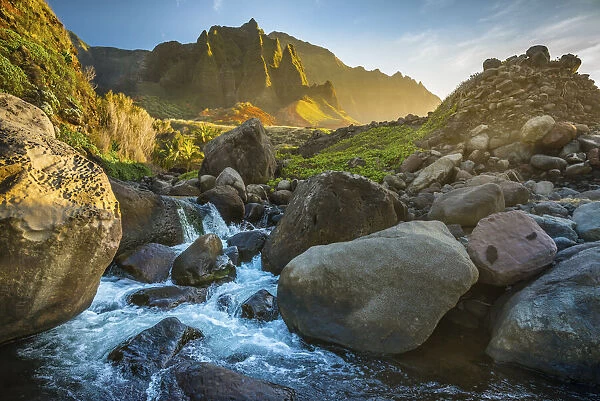 Mountain stream flows from the NaPali Cliffs in the background, Hawaii