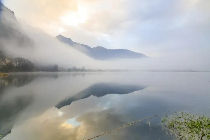 Framed Print : Mountains reflected in water at dawn shrouded by mist, Pozzo di Riva Novate, Mezzola Framed Print : Mountains reflected in water at dawn shrouded by mist, Pozzo di Riva Novate, Mezzola