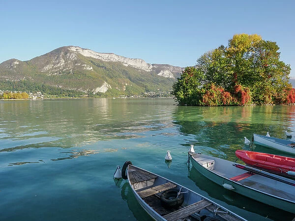 Mountains, small boats, and fall color on Lake Annecy, Annecy, Haute-Savoie, France, Europe