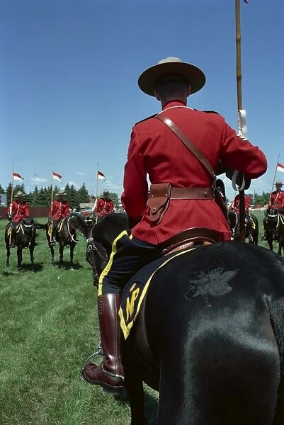 Mounties on horseback during roll call and instructions before performance of show number Musical Ride, at Regina, Saskatchewan, Canada
