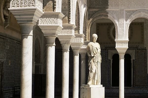 Mudejar arches and Greek statue of Athene in the Patio Principal