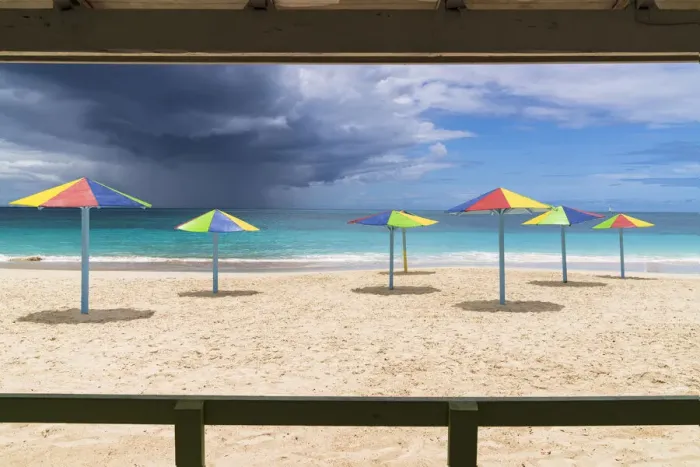 Framed Print : Multicolored striped umbrellas on white sand beach under storm clouds, Antigua, West Indies, Caribbean, Central America Framed Print : Multicolored striped umbrellas on white sand beach under storm clouds, Antigua, West Indies, Caribbean, Central America