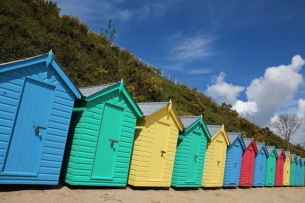 Multicoloured beach huts on the long sweeping beach of Llanbedrog, Llyn Peninsula