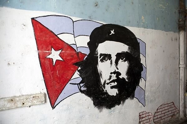 Mural of Che Guevara and the Cuba, West Indies, Central American flag painted on a wall, Havana, Cuba, West Indies, Central America
