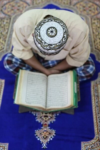 Muslim man reading the Quran in mosque, Ho Chi Minh City, Vietnam, Indochina