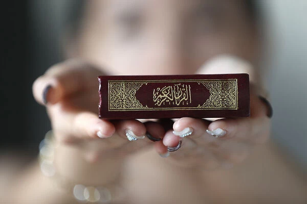 Muslim woman holding the Holy Quran book, Indochina, Southeast Asia, Asia