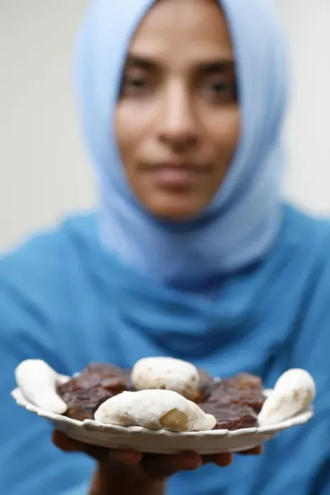 Framed Print : Muslim woman offering Ramadan pastries Framed Print : Muslim woman offering Ramadan pastries
