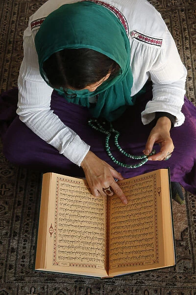 Muslim woman reading Kuran, Montrouge, Hauts-de-Seine, France, Europe