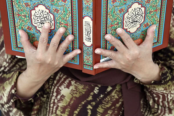 Muslim woman reading the Quran, The National Mosque (Masjid Negara), Kuala Lumpur