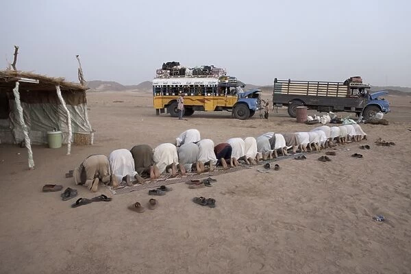 Muslims stop in the Nubian Desert for evening prayers