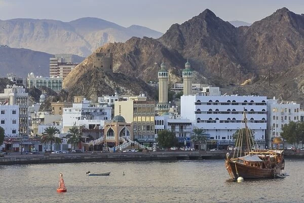 Mutrah Corniche and entrance to Mutrah Souq, backed by mountains, viewed from the sea