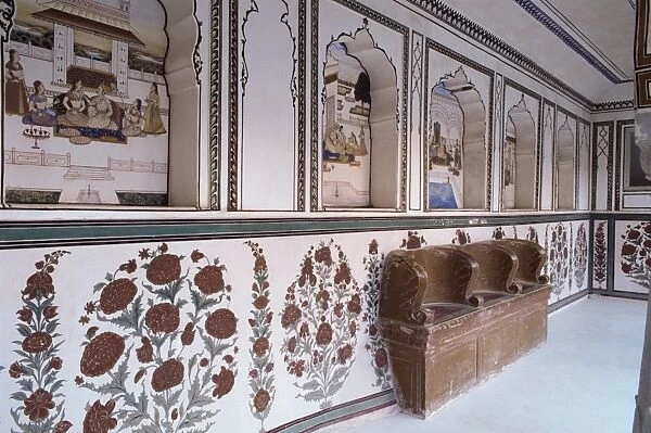 Narrow painted veranda with deep niches and carved