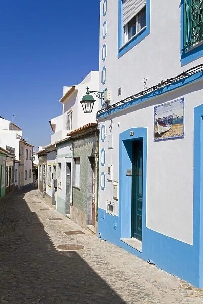 Narrow street in Ferragudo fishing village, Portimao City, Algarve, Portugal, Europe