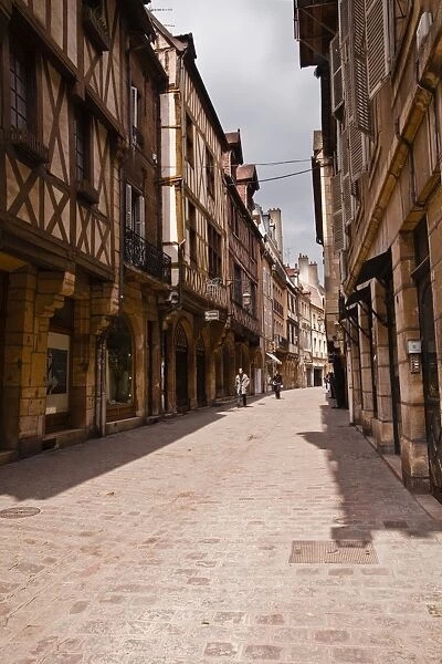 A narrow street with half timbered houses in the old city of Dijon, Burgundy, France, Europe