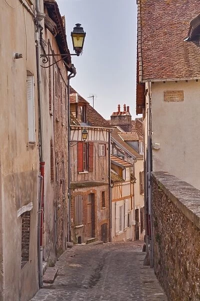 A narrow street of half timbered houses in the town of Joigny, Yonne, Burgundy, France, Europe