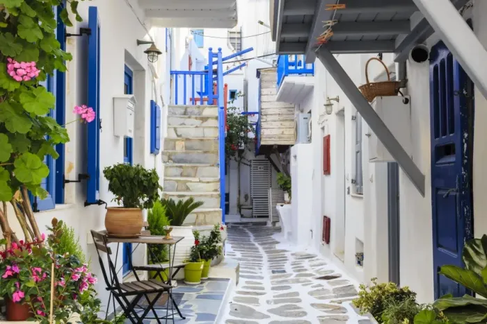 Framed Print : Narrow street, whitewashed buildings with blue paint work, flowers, Mykonos Town (Chora) Framed Print : Narrow street, whitewashed buildings with blue paint work, flowers, Mykonos Town (Chora)