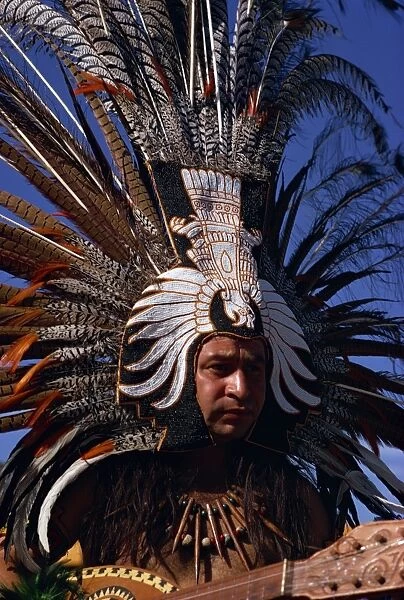 Native American wearing large head dress