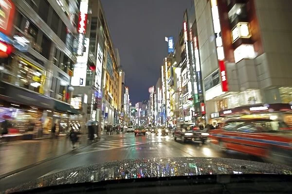 Neon lights on a rainy evening, blurred motion from car, Shinjuku, Tokyo, Japan, Asia