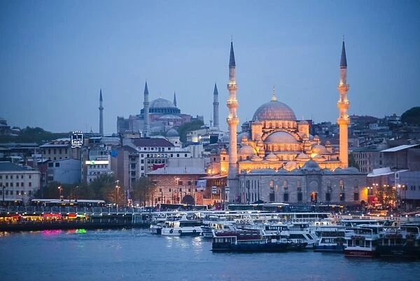 New Mosque (Yeni Cami) at night with Hagia Sophia (Aya Sofya) behind seen across the Golden Horn