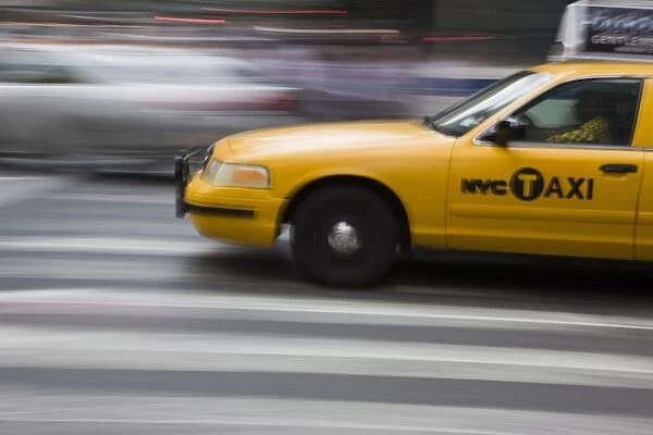 New York taxi cab driving fast over a pedestrian crossing, Manhattan, New York